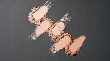 Top Perspective of Beige to Brown Powder on Dark Background