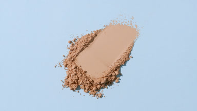 Slow Motion Water Splashing on Beige Powder Heap