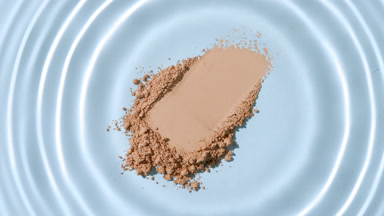 Macro Slow-Motion Droplet Over Beige Powder Heap