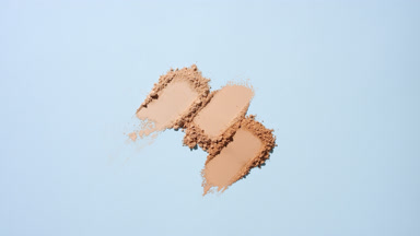 Three Beige Powder Streaks on Pale Blue Background