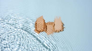 Drop concentric waves over skintone powder smears