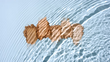 Slow Motion Water Splash Over Skin Tone Powder Heaps