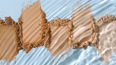 Extreme Close-Up of Water Splashing Over Powder Heaps