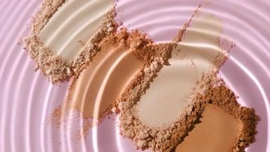 Slow-Motion Water Droplet Creating Ripples on Skin Tone Powders