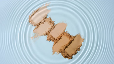 Droplet Creating Circles on Skin Tone Powder Clusters