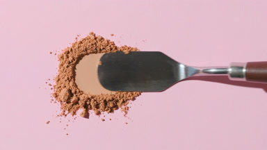 Close-Up of Beige Powder Heap on Soft Gray Background
