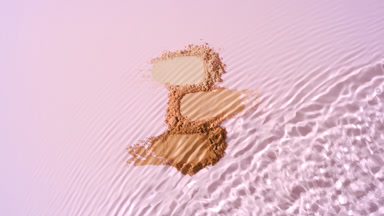Water Stream Splashing on Skin Tone Powder Heaps