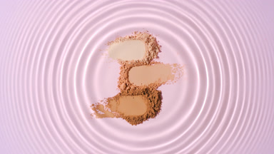 Droplet Creating Circles on Piled Skin Tone Powders