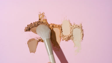 Disrupted Skintone Powder Lumps on Pastel Pink Surface