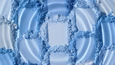Extreme Close-Up of Water Droplet on Blue Powder Heaps