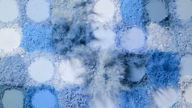 Top View of Blue Powder Heaps Bursting in Slow Motion