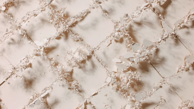 Beige Powder Surface with Notches Bursting in Slow Motion