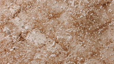 Beige Powder Surface with Cuts Bursting Upward