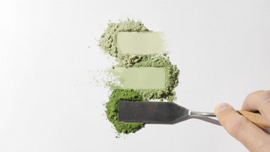 Macro Close-Up of Smeared Pale Green Powder Heaps