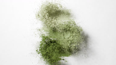 Slow-Motion Burst of Pale Green Powder on Grey