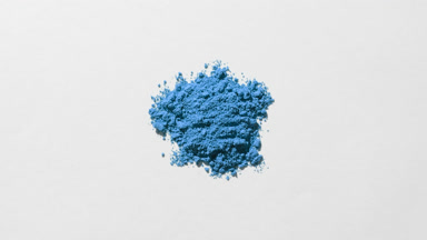Close-Up of Blue Powder Heap on Light Grey Surface