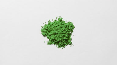 Green Powder Extreme Close-Up on Gentle Grey Surface
