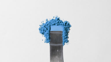 Blue Powder Heap Smoothed on Light Gray Surface