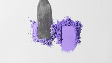 Violet Loose Powder Heaps on Muted Grey Background
