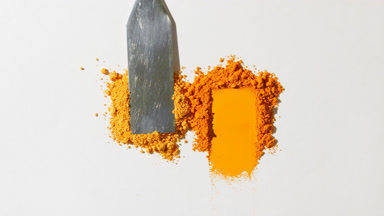 Orange and Yellow Loose Powder Heaps on Light Gray