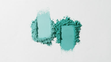 Cyan Shades in Two Smeared Powder Piles on Light Gray