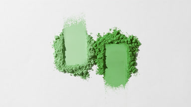 Green Smudged Powder Piles on Light Grey Backdrop