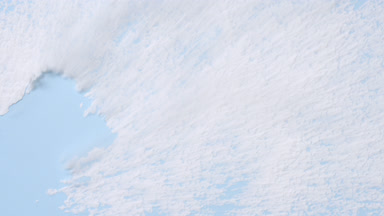 Sifted White Powder on Blue Background Close-Up
