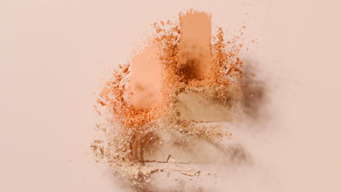 Explosive Beige and Orange Powder Burst in Slow Motion