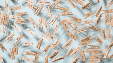 Tumbling Wooden Pins on Pale Blue Background
