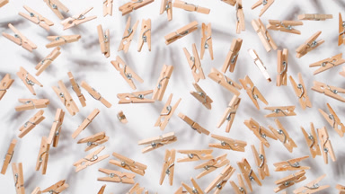 Slow-Motion Jumps of Clothespins on White Backdrop