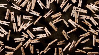 Tumbling Clothespins on Black Background