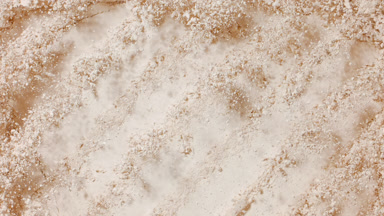 Light Beige Powder Burst with Curved Trails from Above