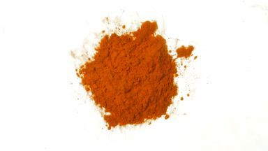 Macro Shot of Orange Dust in Petri Dish on White Canvas