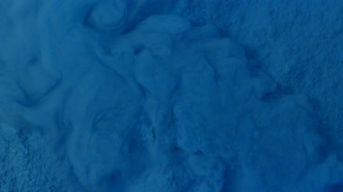Dispersing Blue Powder Underwater in Macro Shot