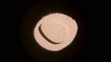 Beige Powder and Teardrop Puff on Black Background