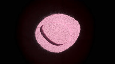 Pink Powder and Puff with Orbiting Light on Black