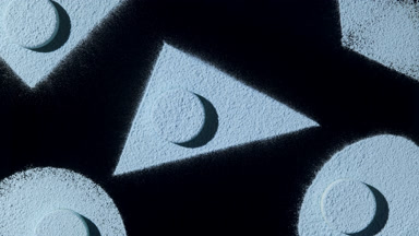 Blue Powder Shapes: Dynamic Forms on Black Background