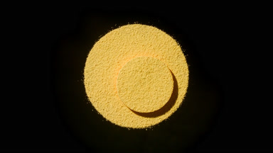 Dynamic Yellow Powder Shadows on Black Background