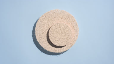 Dynamic Shadows of Beige Powder on Pastel Blue Background