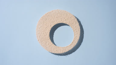 Dynamic Shadows of Beige Powder on Blue Background