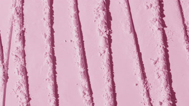 Vertical Shot of Textured Pink Powder Surface with Shadows