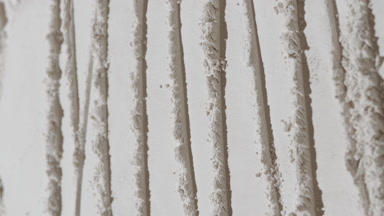 Tracking Shot of White Powder Surface with Knife Patterns