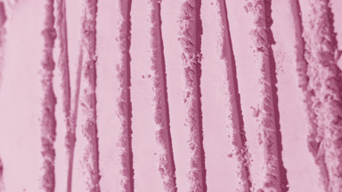 Arc Vertical Shot of Pink Powder Surface with Fluid Shadows