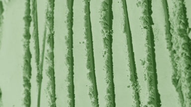 Arc Shot of Pale Green Powder Surface with Changing Shadows