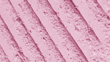 Curved Shot of Pale Pink Powder with Dynamic Light Effects