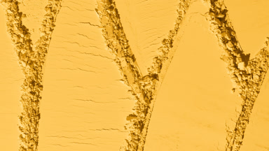 Yellow Powder Surface with Intersecting Scraping Trails