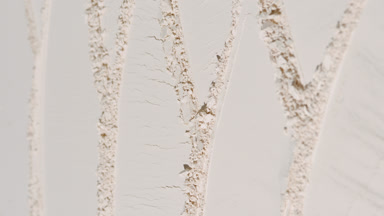 Wide Shot of Beige Powder with Overlapping Knife Trails