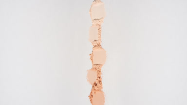 Skin Tone Powder Smudges on Subtle Grey Surface