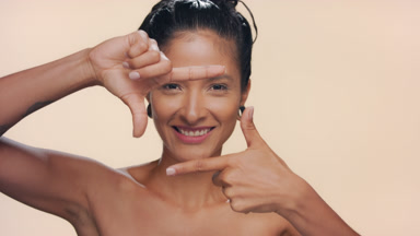 Argentinian woman with honey skin frames face smiles pure skin