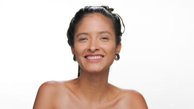 Positive latin woman with light brown smooth healthy skin smiles